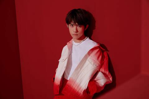 Jackson Yee wearing red faded denim jacket over white tshirt on red background