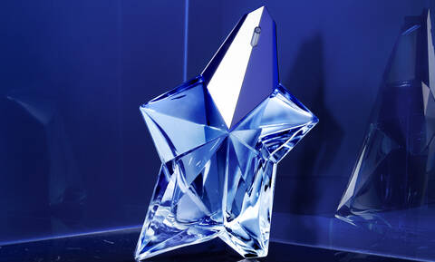 Mugler Angel in iconic crystal star shaped bottle reflecting upon blue background