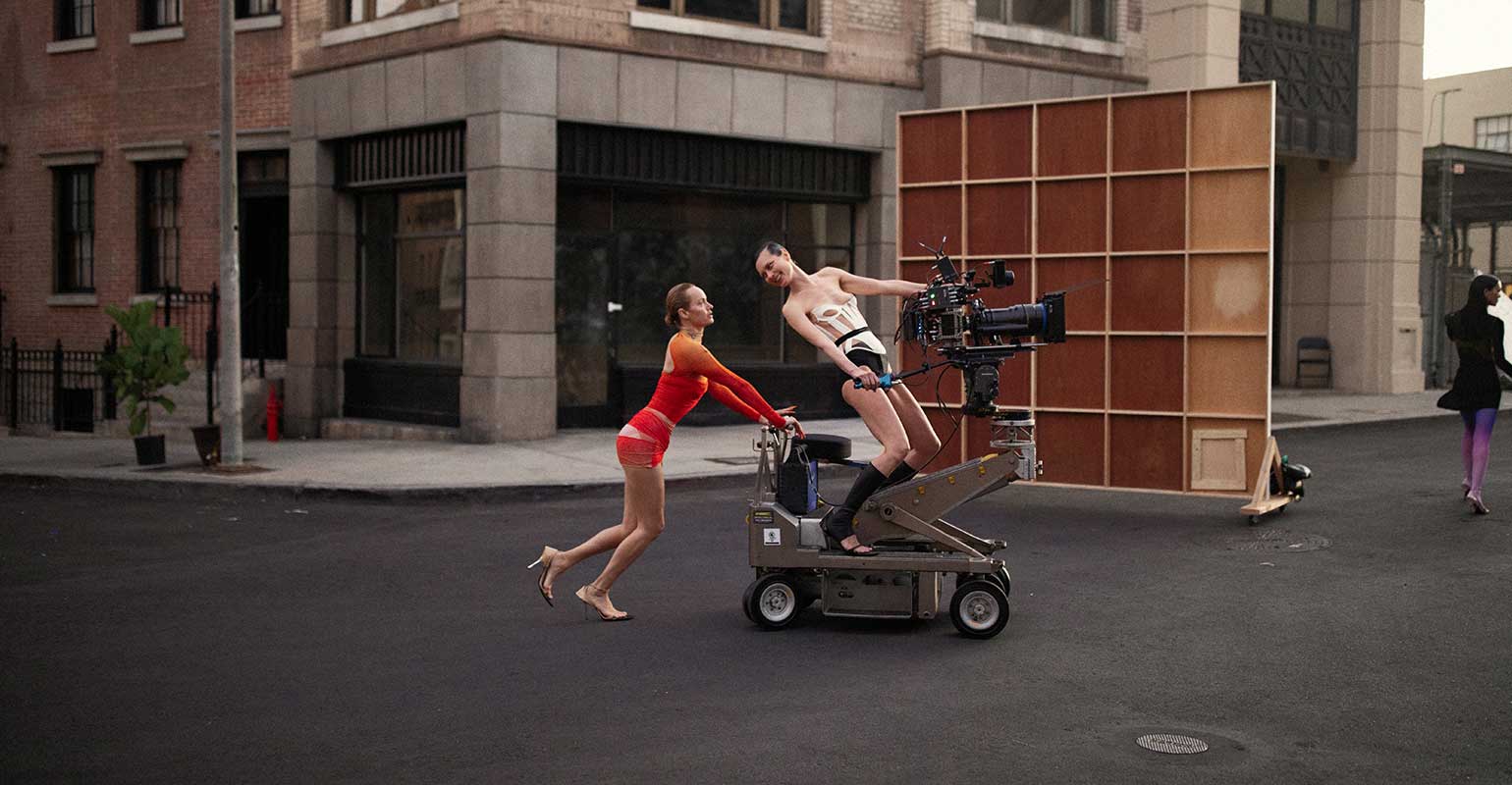 Two models on riding camera on set for Mugler commercial