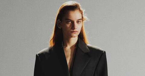 Bust image of model with ear cuff and oversized black blazer