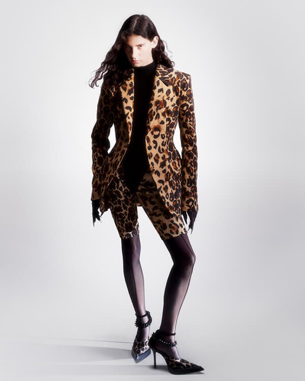 Model in leopard blazer and shorts at fashion show