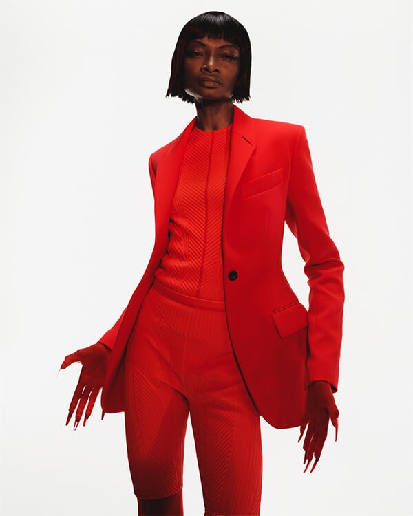 model in red Mugler business suit