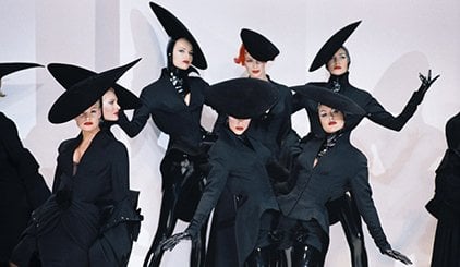 Fashion models in black suits and large. Black hats